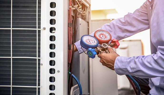 a professional performing maintenance on an air conditioner