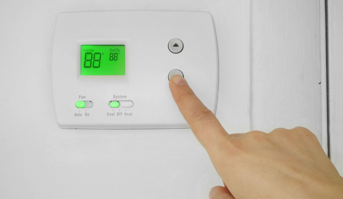 Adjusting digital hvac thermostat temperature