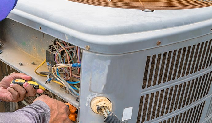 Worker repairing ac