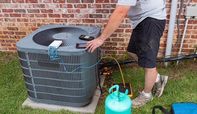 Technician maintaining AC