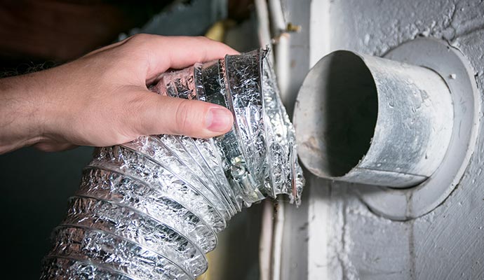 Worker replacing air duct