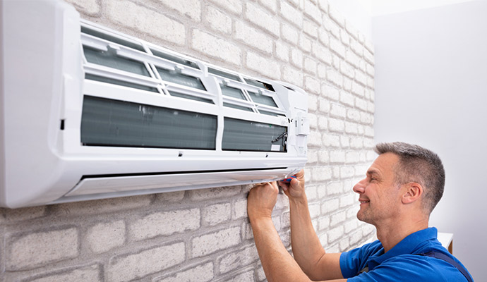 Serviceman Installing AC