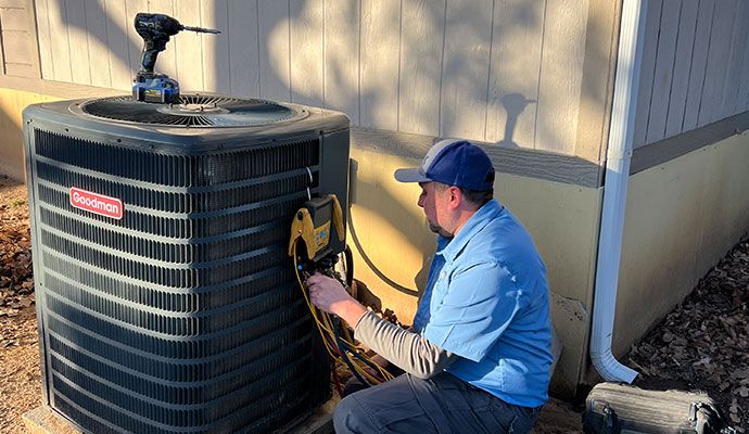 An expert installing an outdoor air conditioning unit