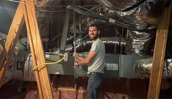 Expert providing repair services for an air handler unit ductwork