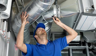 Worker repairing ductwork