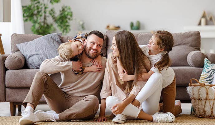 Happy family sitting inside living room