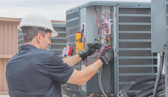 worker repairing heating component