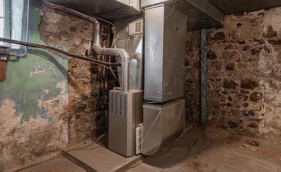 a damaged furnance in a basement