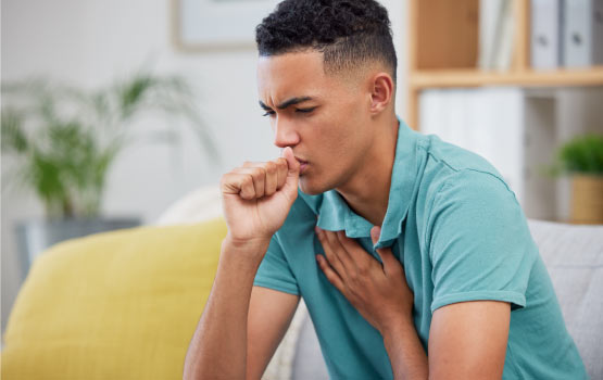 a man coughing in living