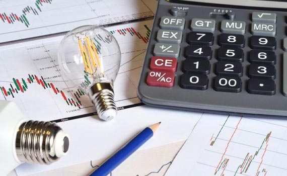 calculator,pencil on a chat showing the rising of energy bill