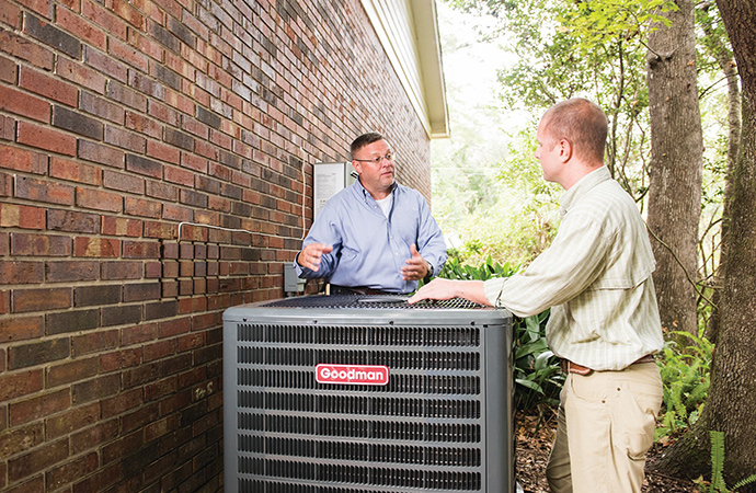Homeowner with HVAC expert and heating pump
