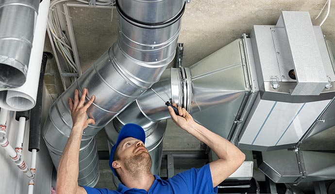 Skilled worker performing HVAC ductwork services