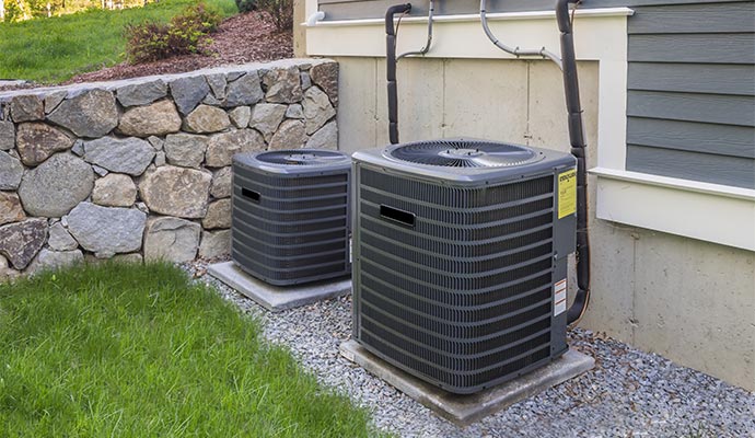 Pair of HVAC units installed outside a residential home