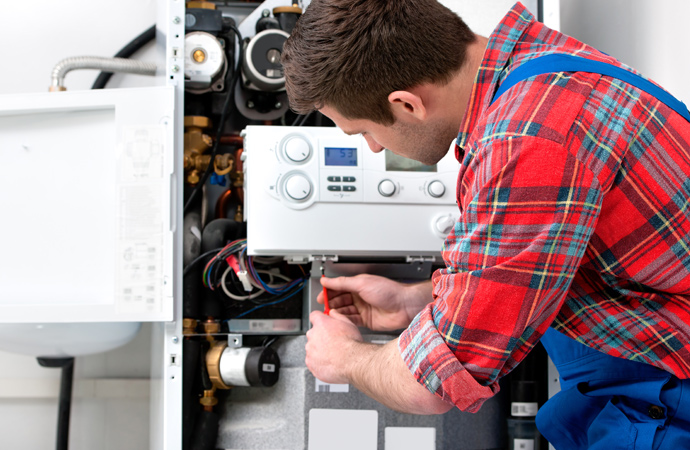 Expert fixing a home boiler.