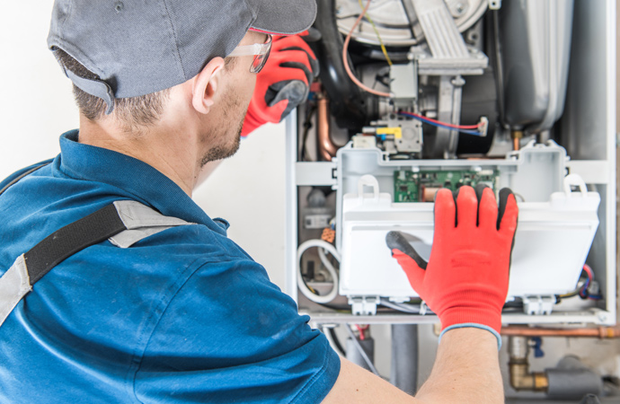 Experts repairing a furnace.